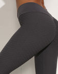 Seamless nylon moisture-wicking sports leggings for fitness, featuring hip lift design and breathable fabric.