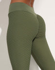 Seamless green nylon moisture-wicking leggings for yoga and fitness, designed for comfort and style.