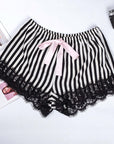 Pink ribbon black and white striped satin pajama shorts with lace trim, perfect for summer home wear.