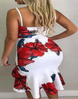 Back view of a woman in a halter irregular skirt dress featuring a white base with vibrant red floral patterns.