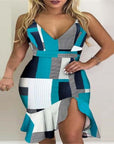 Woman in a collage-pattern halter dress with a MIDI length and irregular hem, showcasing vibrant teal and geometric designs.