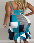 Back view of a woman wearing a blue and black collage halter irregular midi skirt dress in stylish design.