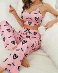 Woman wearing pink milk silk suspender pajamas with heart patterns, perfect for casual and comfortable home wear.