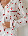 White cotton pajamas with red heart print and long sleeves, perfect for comfortable sleepwear.