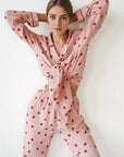 Comfortable soft heart printed cotton pajamas suit on model, featuring long sleeves and trousers in a stylish pink color.