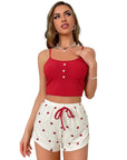 Model wearing red sleeveless top and heart-patterned shorts, perfect for outdoor style pajamas.