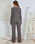 Back view of a woman in gray waffle long sleeve pajamas, showcasing comfort and style in a cozy setting.