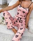 Two-piece pink milk silk suspender pajamas with heart pattern, ideal for casual and sleepwear.