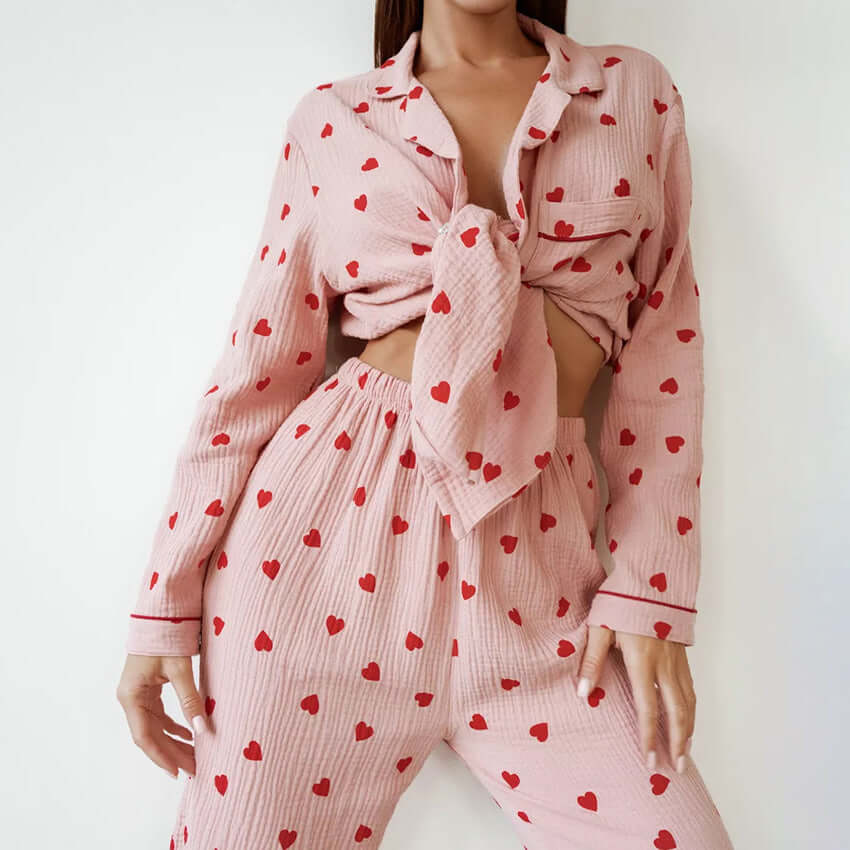 Comfortable pink cotton pajamas set with heart print, featuring long sleeves and tied crop top.